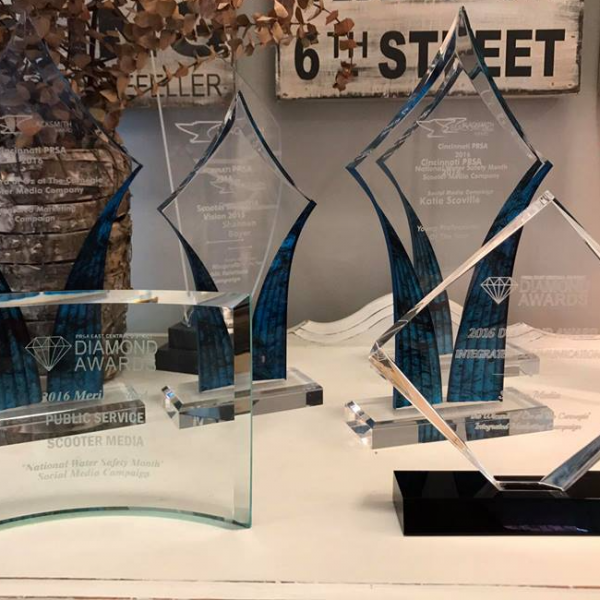 five glass awards on a table