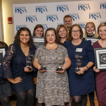 Scooter Media group photo holding awards from Cincinnati PRSA's Annual Blacksmith Awards