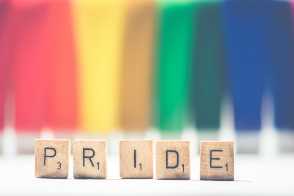 Pride Scrabble Tiles in front of rainbow