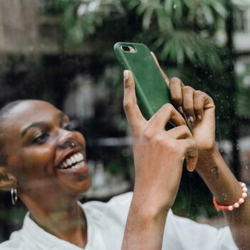 Woman holding phone and smiling