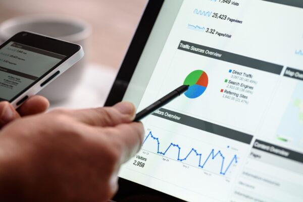 hand pointing to screen with digital marketing graphs
