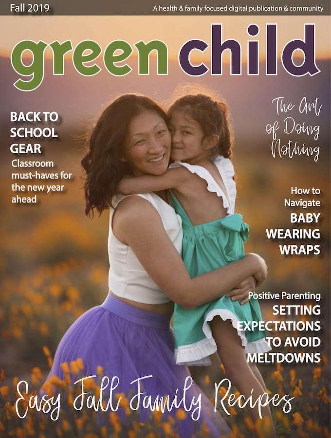 The cover of an issue of "Green Child Magazine" featuring a mother hugging her young daughter