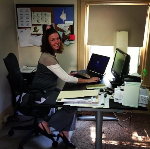 Shannan Boyer President & Founder of Scooter Media, sits at her desk in the agency's first office