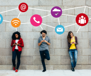 three people standing in front of a building on their phones 