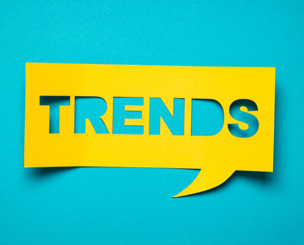 Yellow text bubble with the word "trends" set on top of a teal background