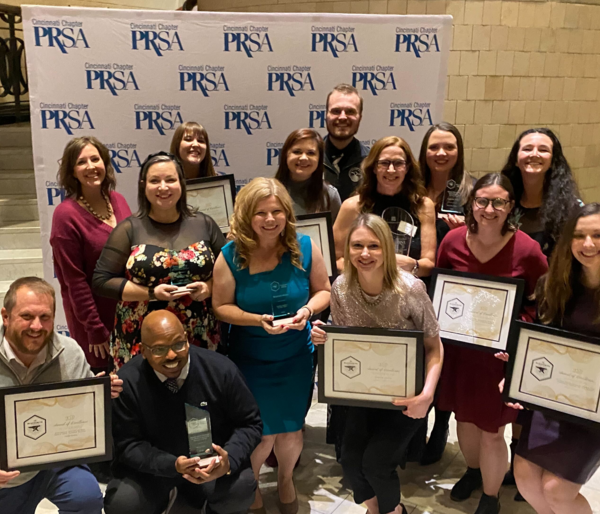 Scooter Media staff members posing with awards at the 2022 Cincinnati PRSA Blacksmith Awards