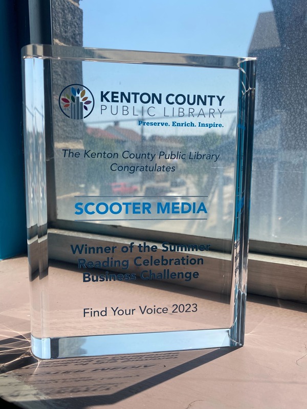 A trophy of a glass book from the KCPL Summer Reading Challenge